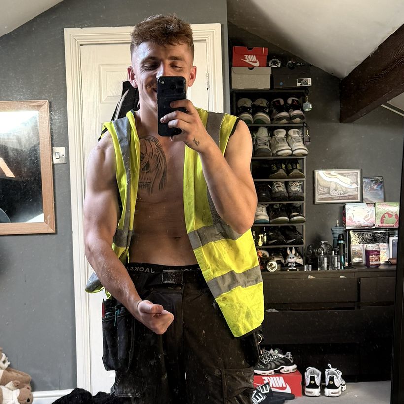 Mirror selfie in a hi-vis vest and work trousers